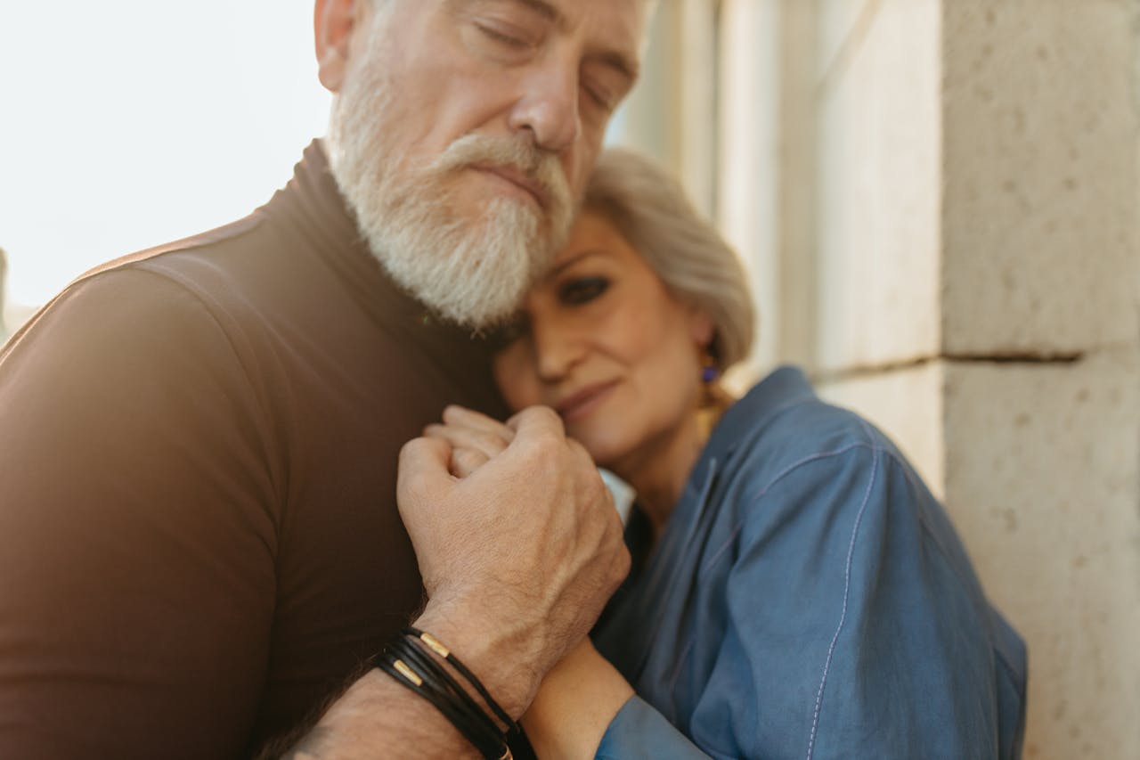 Tender portrait of an elderly couple embracing, showcasing love and affection.